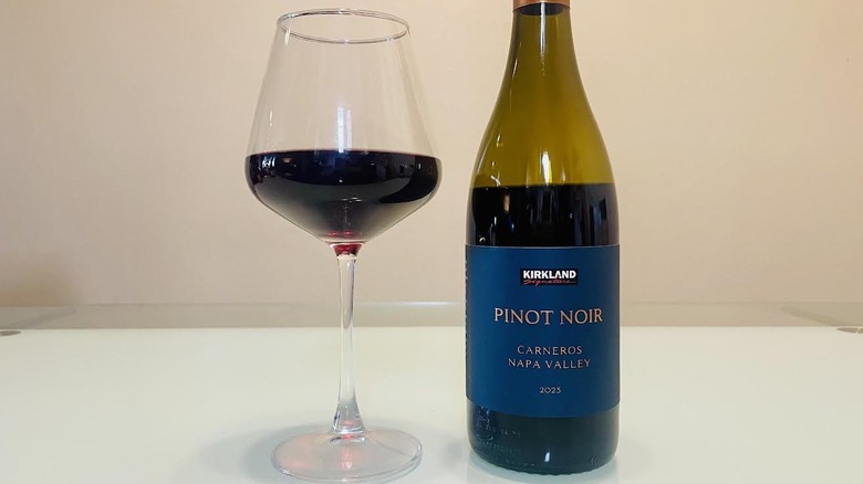 Glass and bottle of Kirkland Signature Pinot Noir