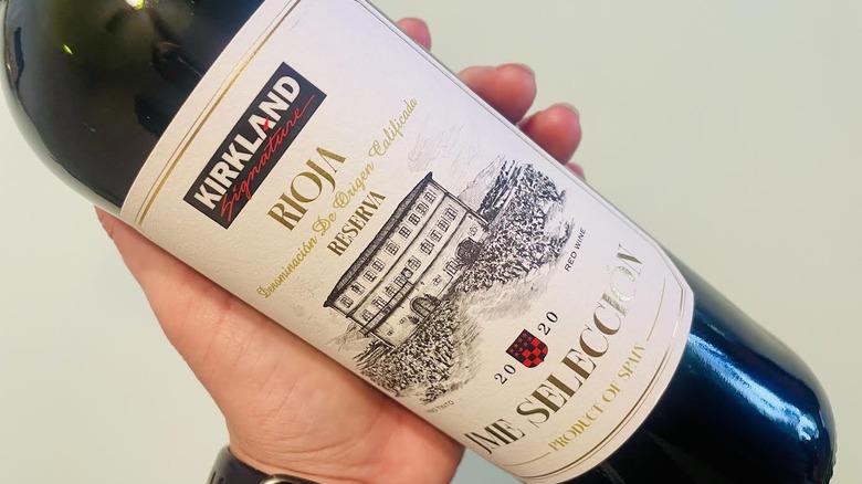 Hand holding bottle of Kirkland Signature Rioja Reserva