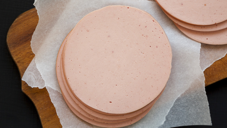 Sliced bologna rounds on a cutting board