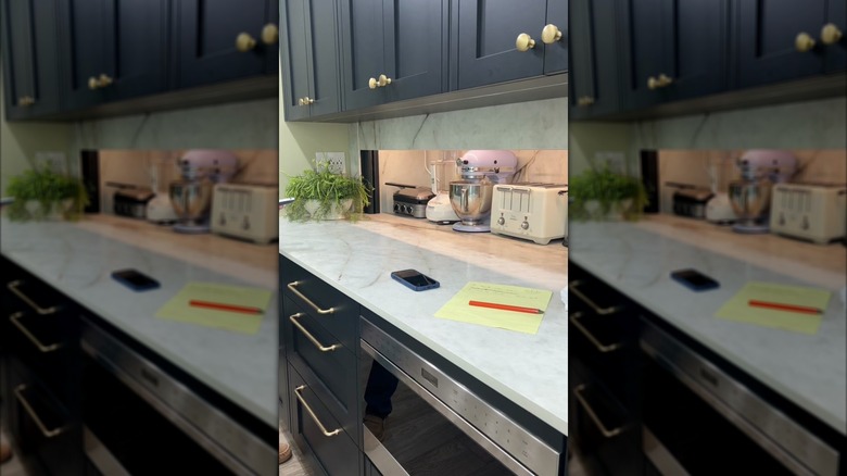 Appliance garage hidden behind a marble backspash