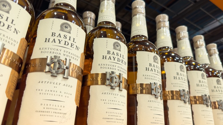 Bottles of Basil Hayden lined up on shelf
