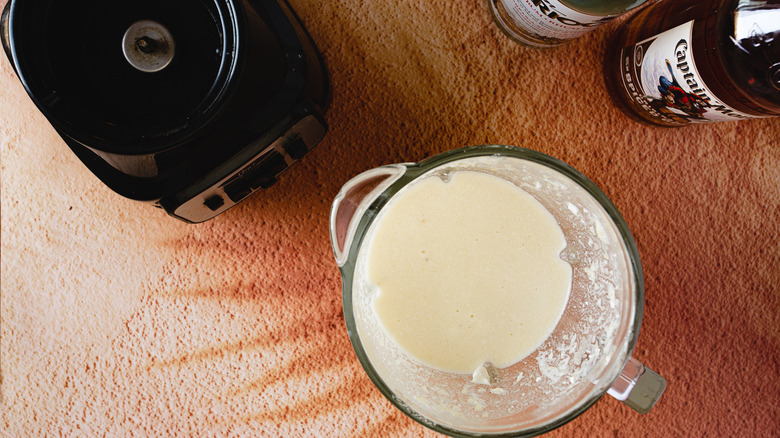 pitcher with blender and rum bottles