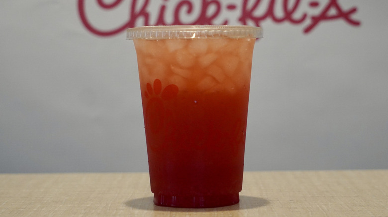 Cherry Berry Sunjoy on a tan table in front of a white Chick-fil-A step and repeat