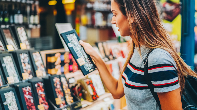 Woman buying chocolate bar