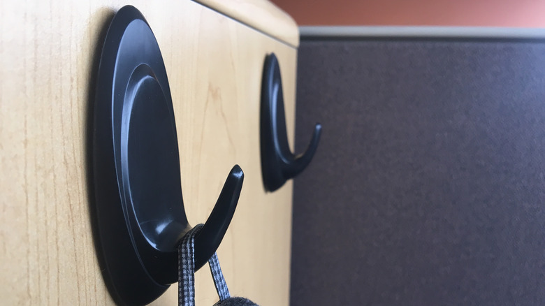 Matte black Command hooks on wooden siding