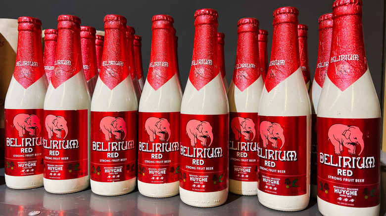 Multiple bottles of Delirium Red beer on store shelf