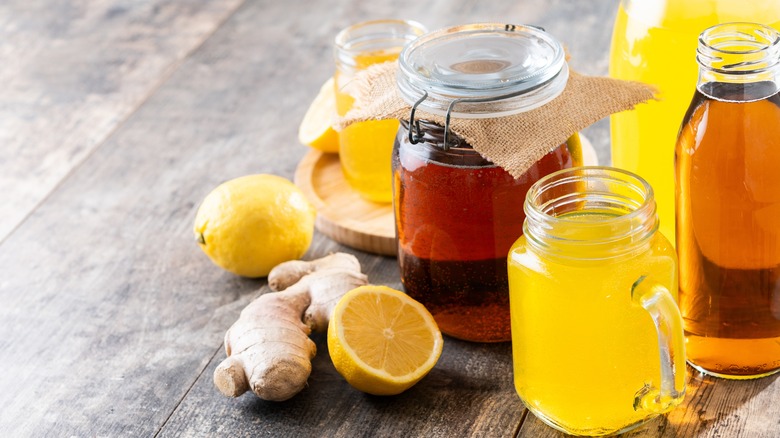 Lemon and ginger kombucha jars on table.