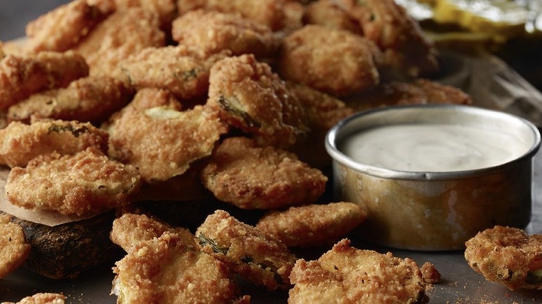 Crispy fried pickles served with a creamy dipping sauce
