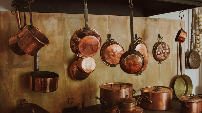 Copper pots and pans hanging in a kitchen