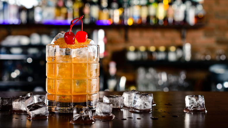 A harvey wallbanger on a bar with ice cubes around it