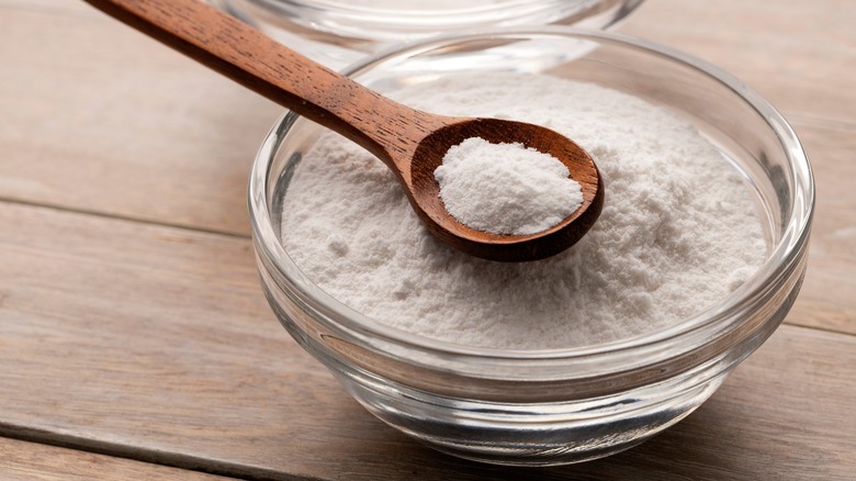 Wooden spoon in bowl of baking soda