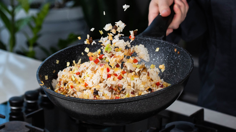 Rice being cooked in a wok.