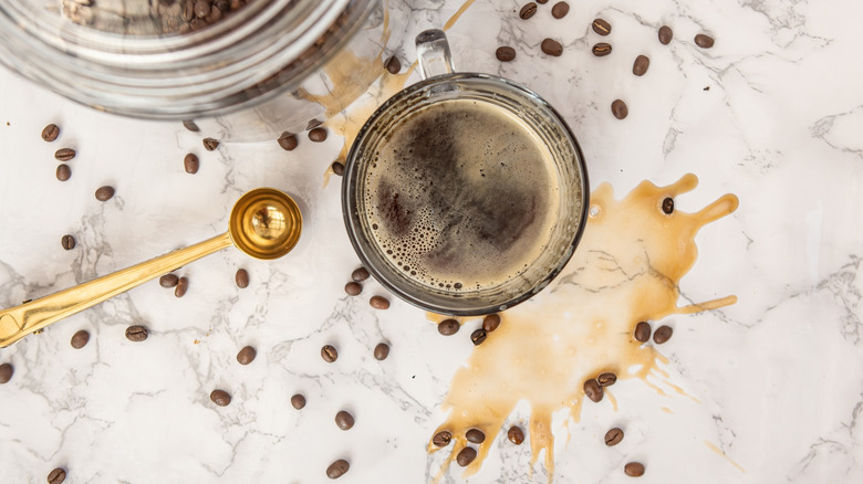 Coffee spill all over white and grey marble countertop