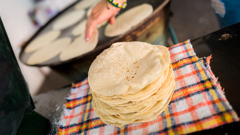 Tortilla stack next to a comal