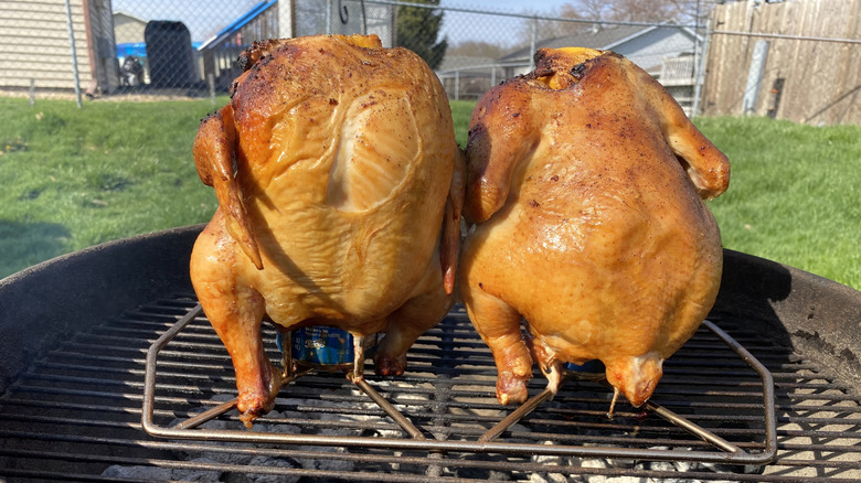 Two full beer can chickens on the grill
