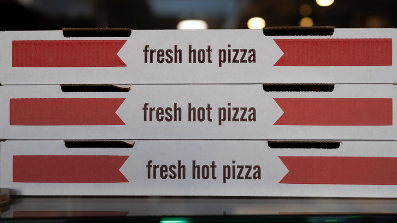 A stack of three pizza boxes