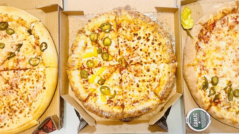 Three stuffed crust pizzas in open boxes