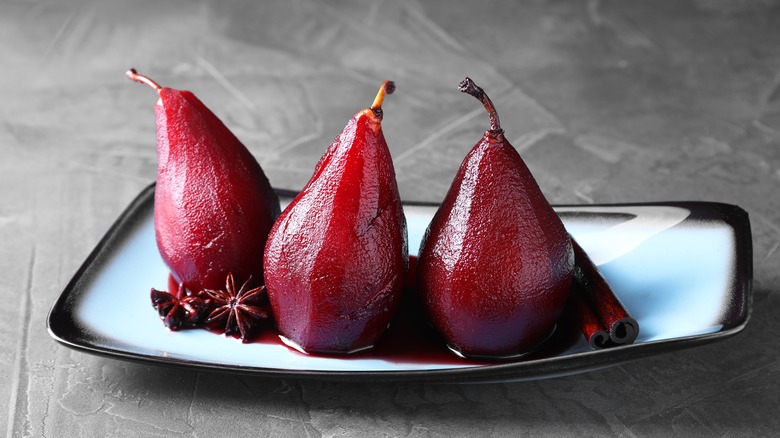 Pears poached in red wine and star anise on a plate