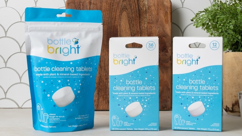 Bottle Bright products lined up on a kitchen counter in front of cutting board