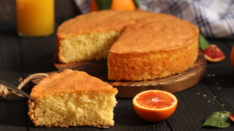 An orange cake on a wooden table