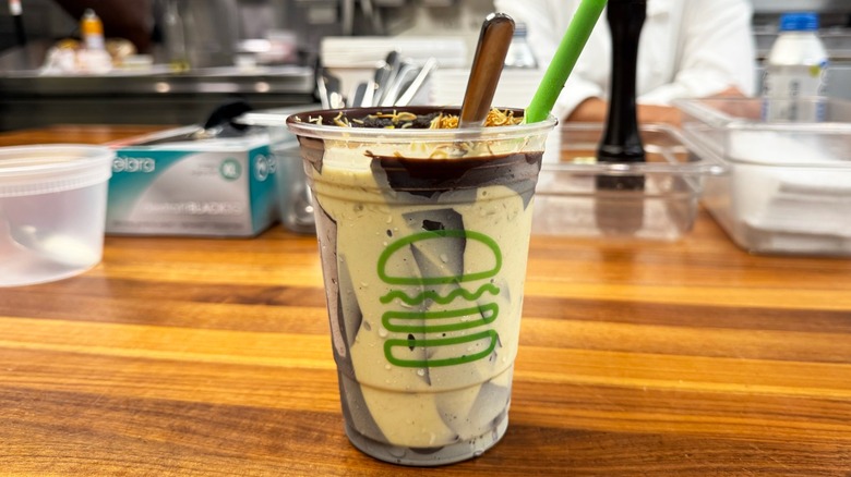 Shake Shack Dubai Chocolate Pistachio Shake, cracked with spoon