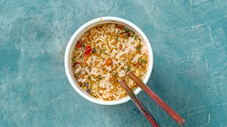 Cup of instant noodles with wooden chopsticks