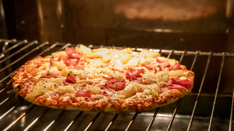 Pizza cooking on an oven rack
