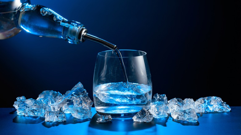 Vodka being poured from a bottle to a glass