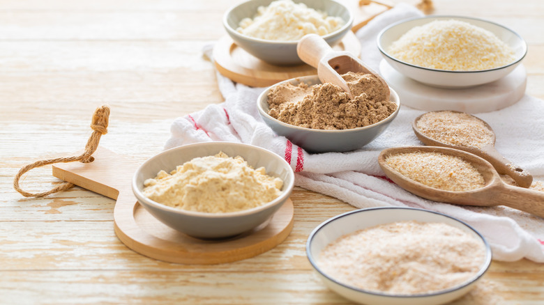 Various gluten-free flours in bowls and spoons
