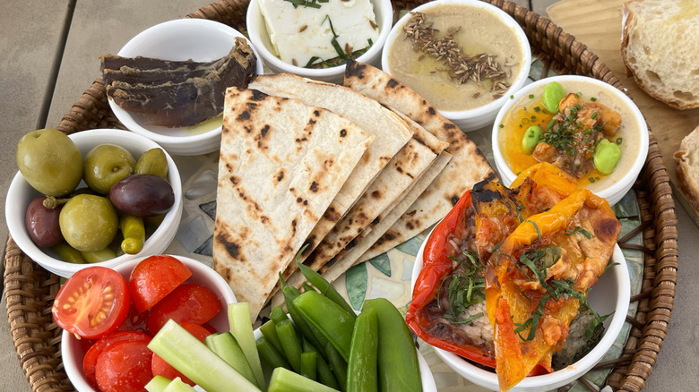 Mediterranean flatbread with a variety of sides.