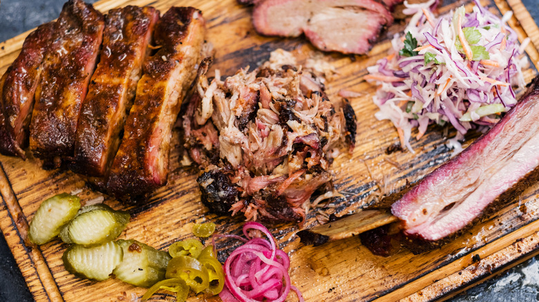 Brisket and pulled pork on a platter with barbecue sides