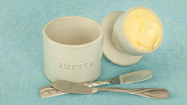 An old fashioned butter bell, displayed open with butter inside.