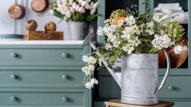 a watering can flower pot in a country style kitchen