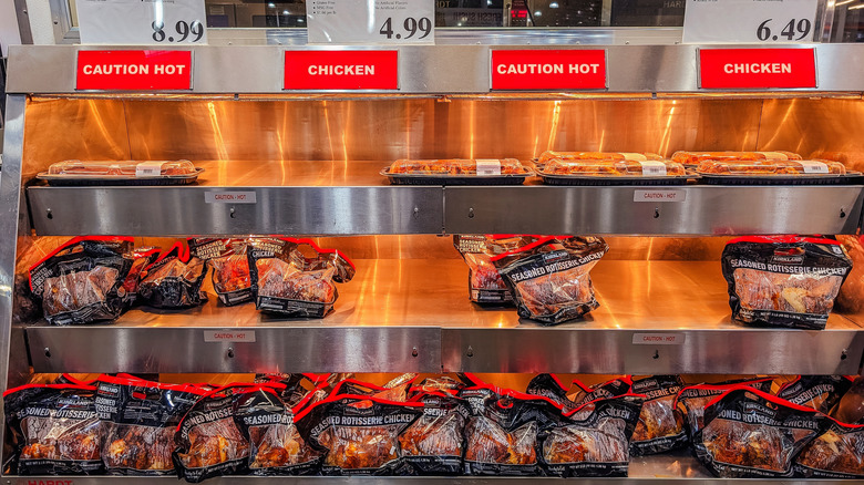 Selection of Costco's rotisserie chickens in the warming section of a Costco deli