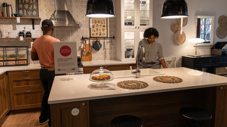 Customers in an IKEA show kitchen