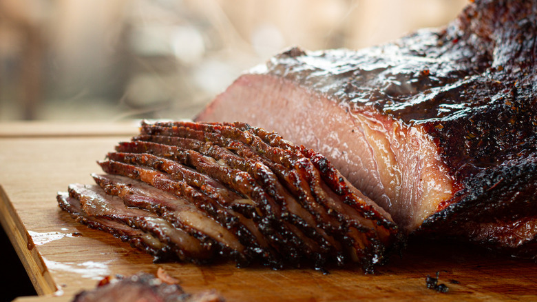 Juicy beef brisket sliced on a cutting board.