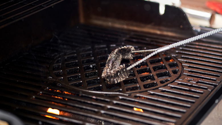Cleaning a grill grate with cutouts with a metal brush