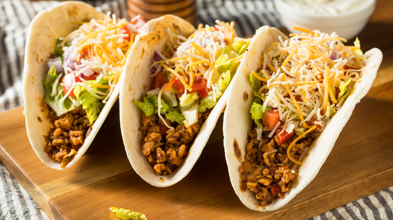 Three beef tacos with toppings