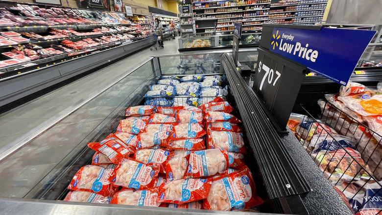 A frozen display of Great Value shrimp sits in the center of an aisle in a Walmart store