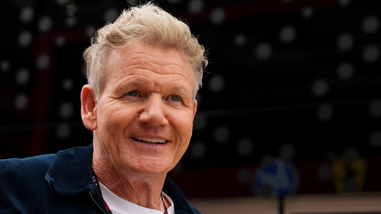 Gordon Ramsay smiles and looks into the distance