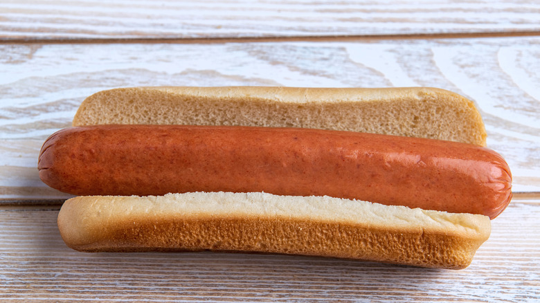 Plain hot dog on a wooden surface