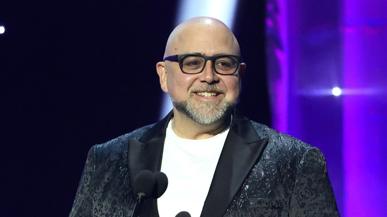 Duff Goldman smiles on stage at an awards ceremony.