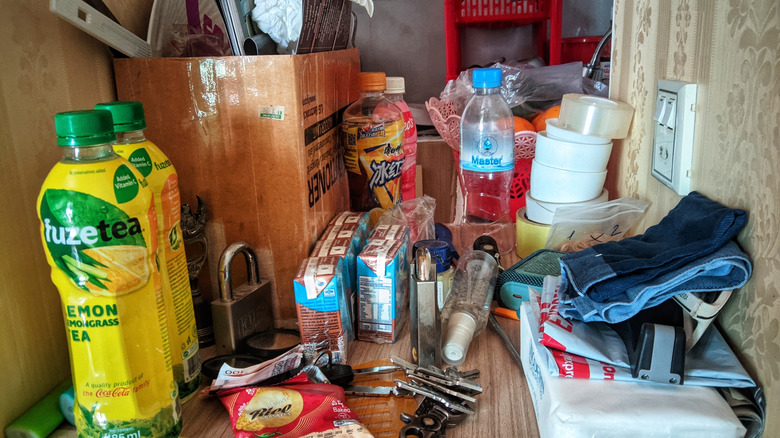 a cluttered kitchen countertop in need of organizing