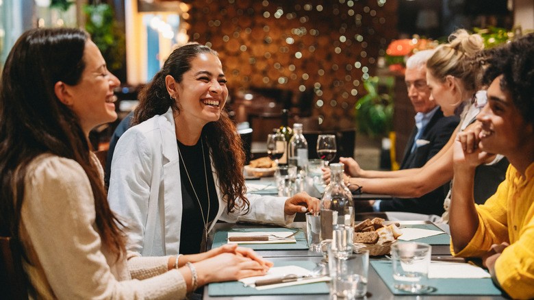 Group of women eating dinner and laughing