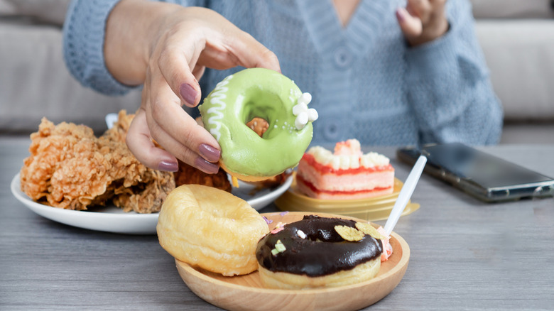 person grabbing for a donut