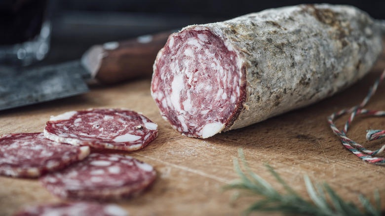 Log of salami near slices