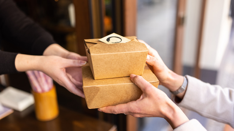 takeaway boxes handed to customer