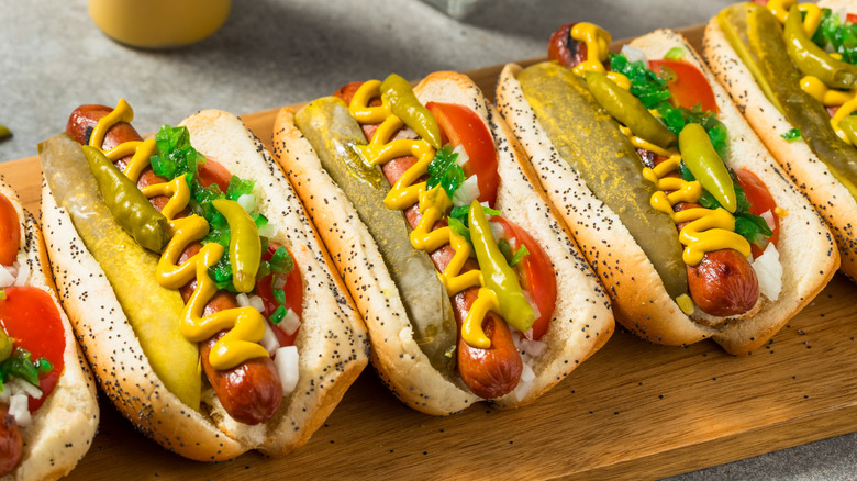 Chicago-style hot dogs on a wooden board