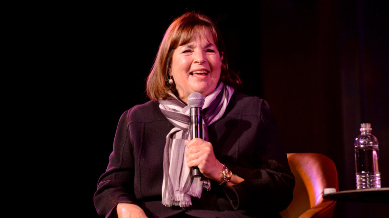 Ina Garten holds a mic and smiles on stage