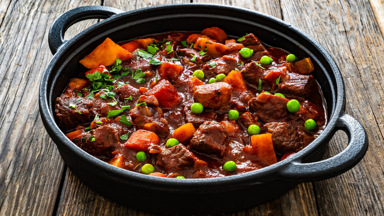 A cast iron pot of beef and carrot stew